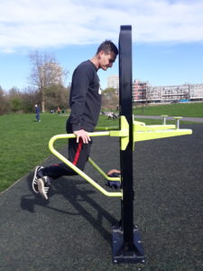A man works out in an outdoor gym